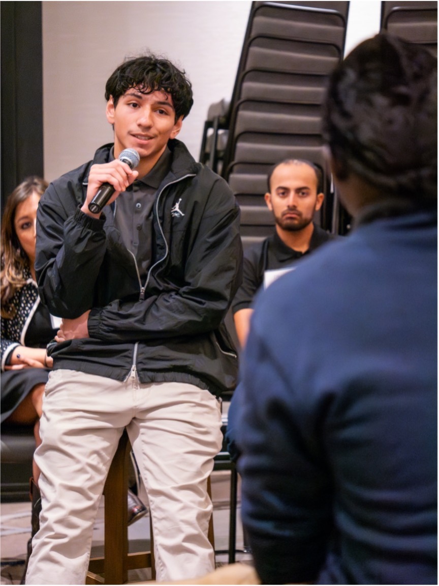 Student speaking into a microphone.