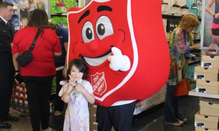 Little girl with Salvation Army symbol.